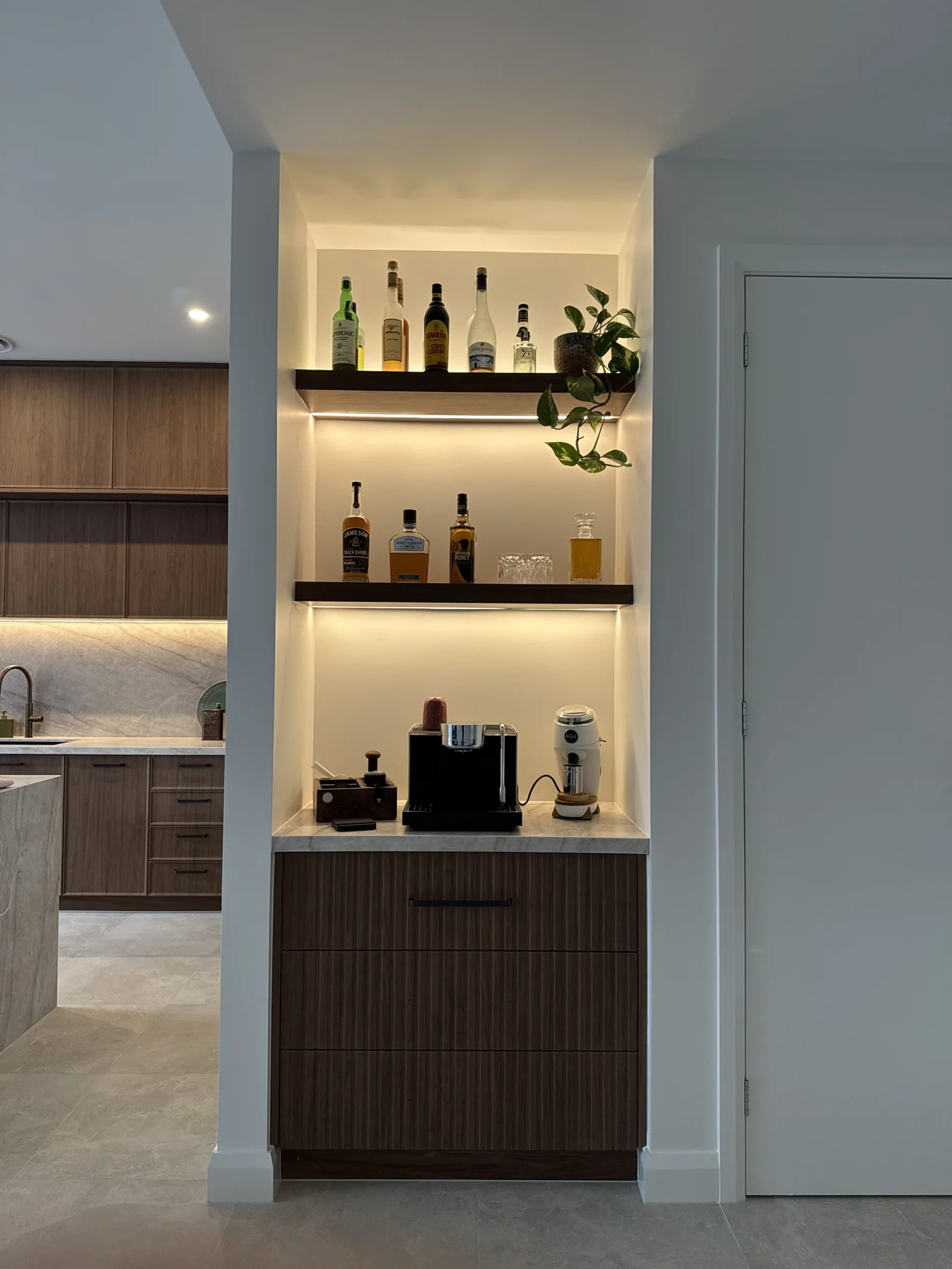 Integrated lighting illuminating timber joinery and display shelves